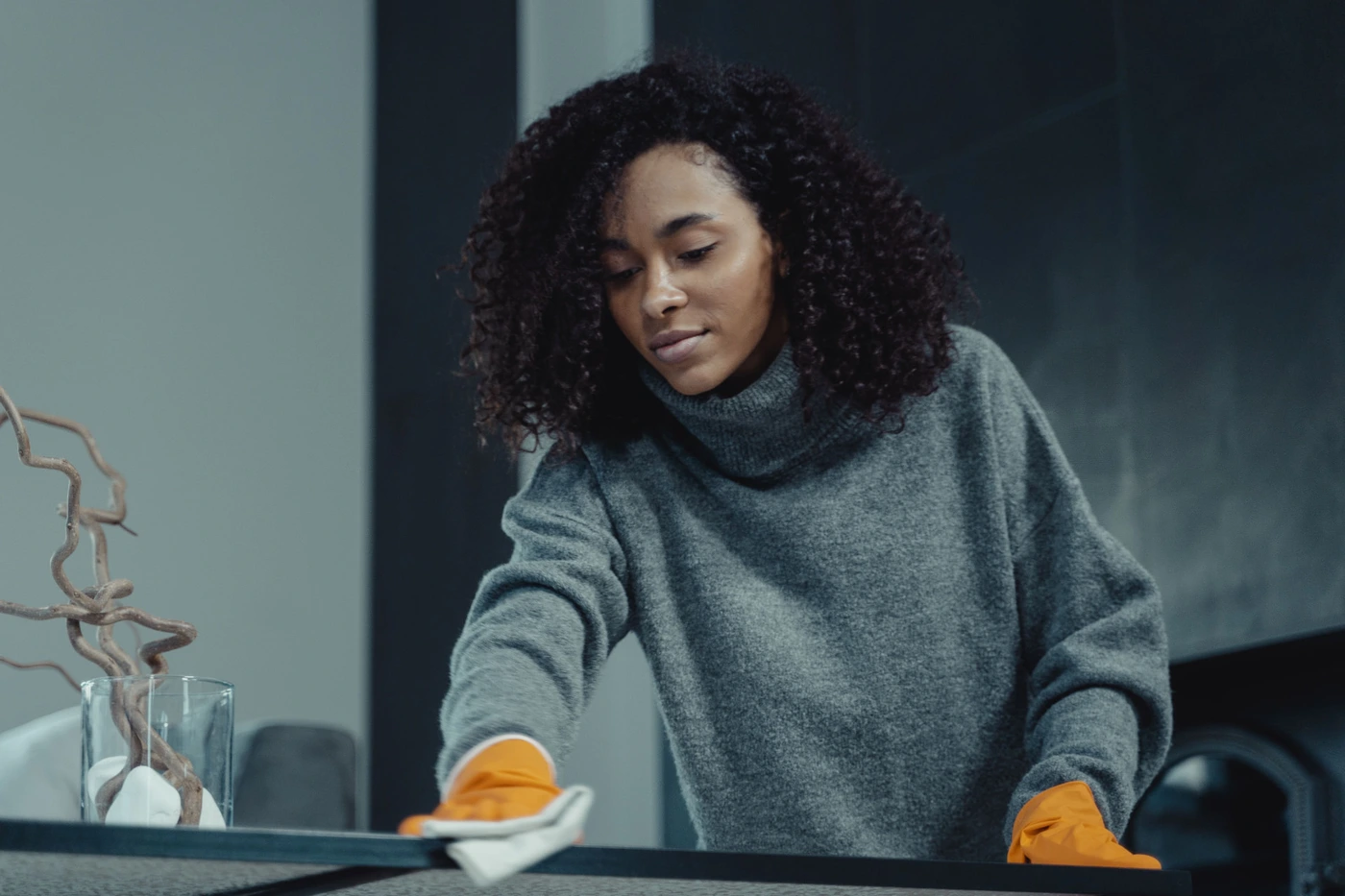 Cleaner wiping down a table during a standard home cleaning
